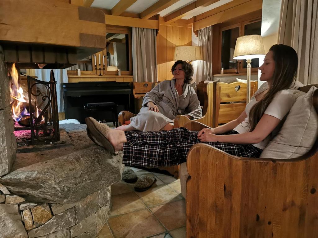 レ・ズッシュにあるThendia Montblancの暖炉の前に椅子に座る女性2人