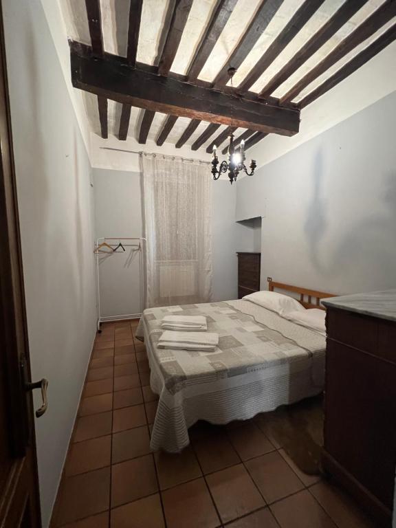 a bedroom with a bed and a wooden ceiling at Locanda Del Duca in Gubbio