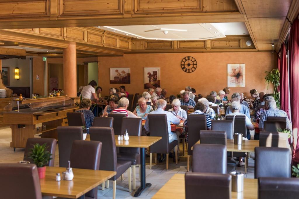 a crowd of people sitting at tables in a restaurant at Hotel Belle Vue in Vianden