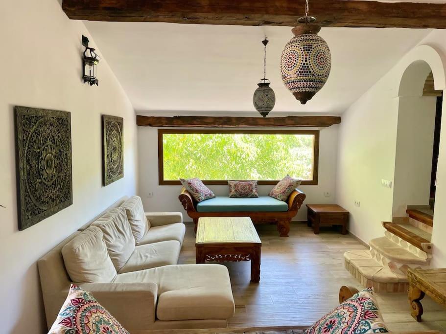 a living room with a couch and a table at Cortijo la Noria II in Puebla de Don Fadrique