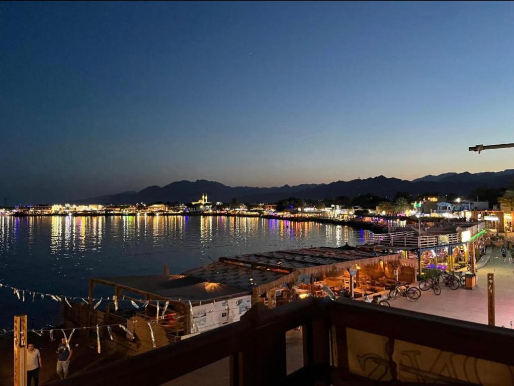 a view of a marina at night at Dahab , property company Lighthouse area in Dahab