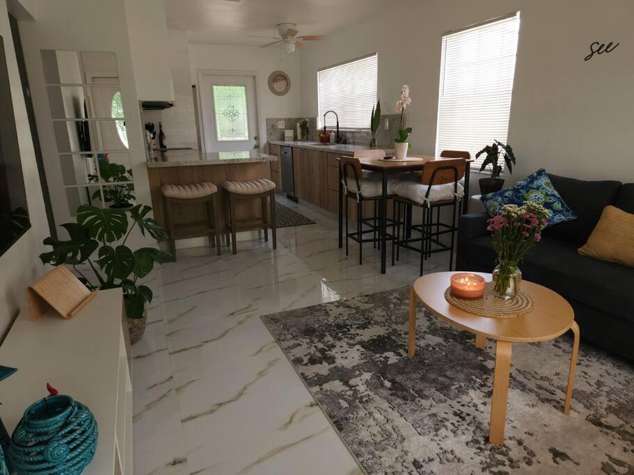 a living room with a couch and a table at Charming Home Away From Home in Fort Lauderdale