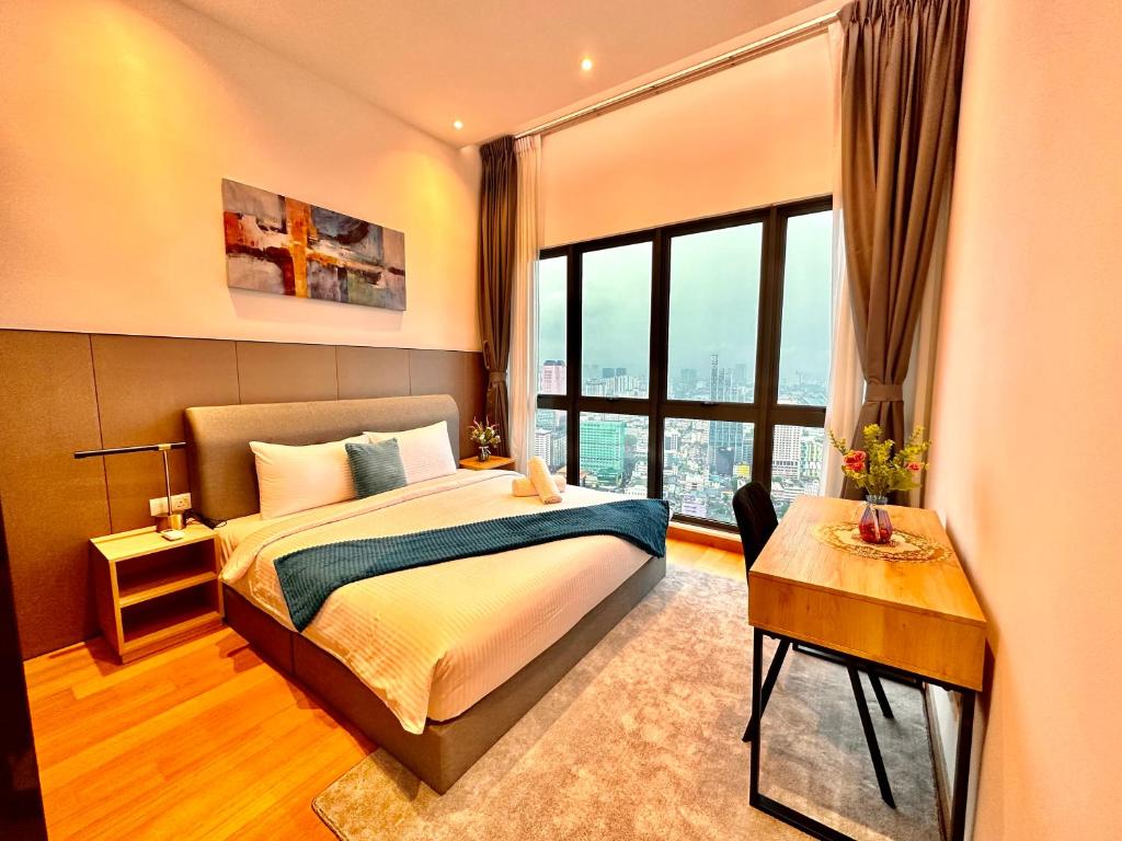 a bedroom with a bed and a large window at The Luxe Colony KLCC BY Infinitum in Kuala Lumpur