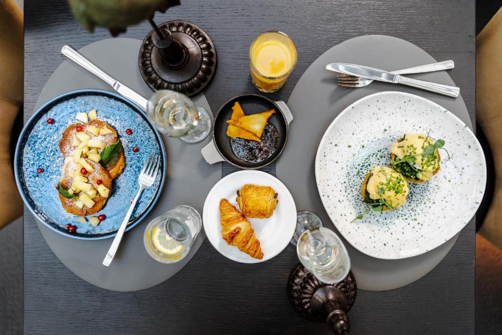 a table with three plates of food on it at H15 Boutique Hotel, Warsaw, a Member of Design Hotels in Warsaw