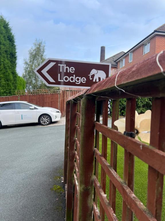 a sign for the lodge on a fence at The Lodge Oldham in Oldham