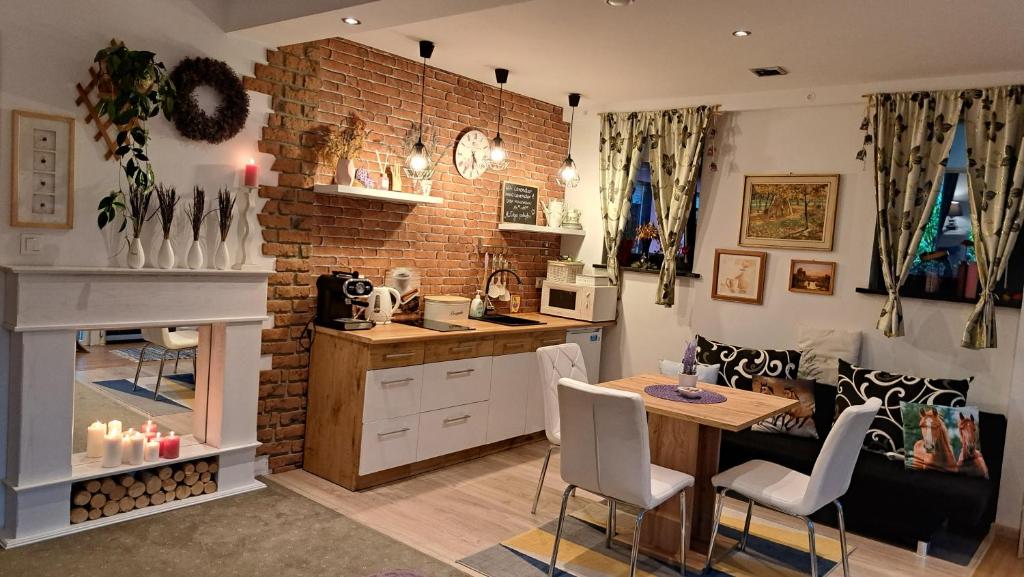 a kitchen and dining room with a table and chairs at Apartament Lavender in Jelenia Góra