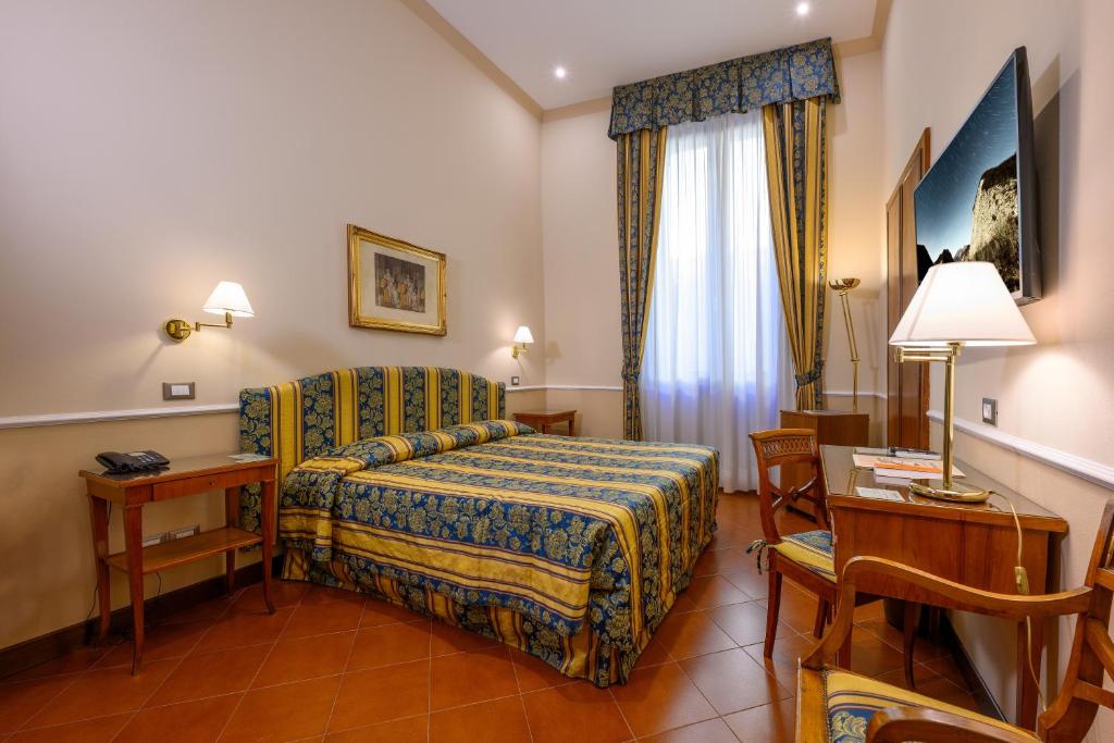 Postel nebo postele na pokoji v ubytování Hotel Posta