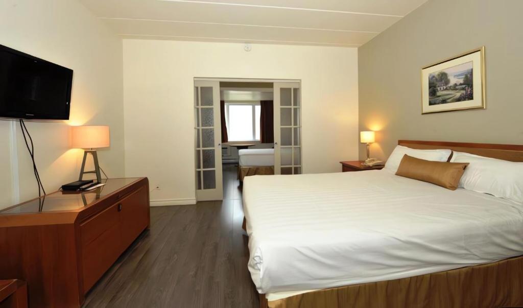 Postel nebo postele na pokoji v ubytování Hotel Le Voyageur