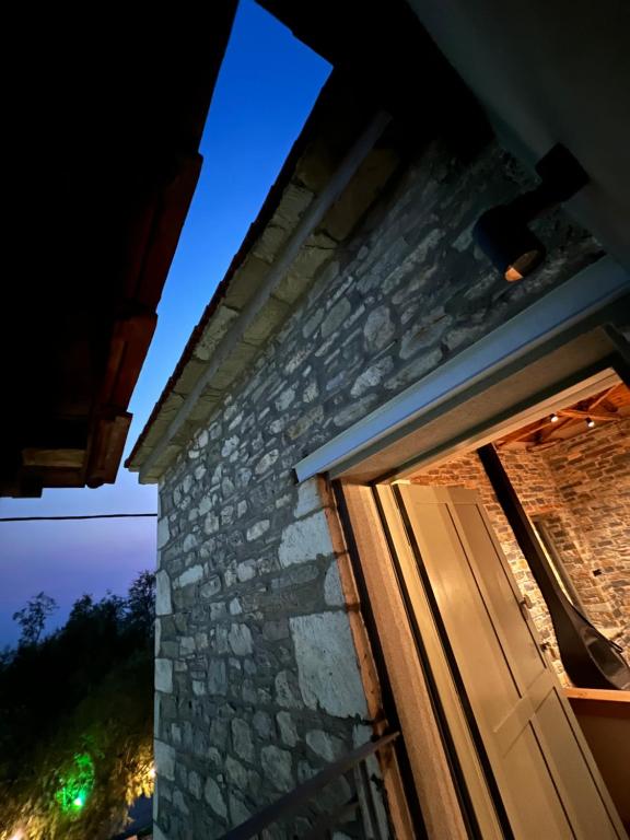 a door to a stone house at night at EJ Boutique Suites in Milina