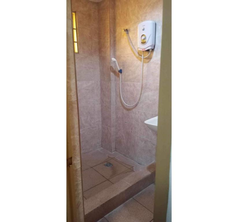 a bathroom with a shower and a sink at OYO 1026 Evita Hotel Bacoor in Cavite