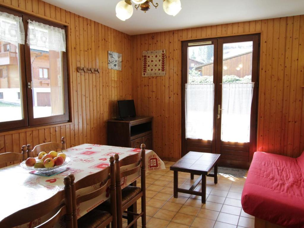 une salle à manger avec une table, des chaises et une télévision dans l'établissement Appartement 6 pers, 54m², à 400m des pistes, Le Grand-Bornand Village, animaux admis - FR-1-467-76, au Grand-Bornand
