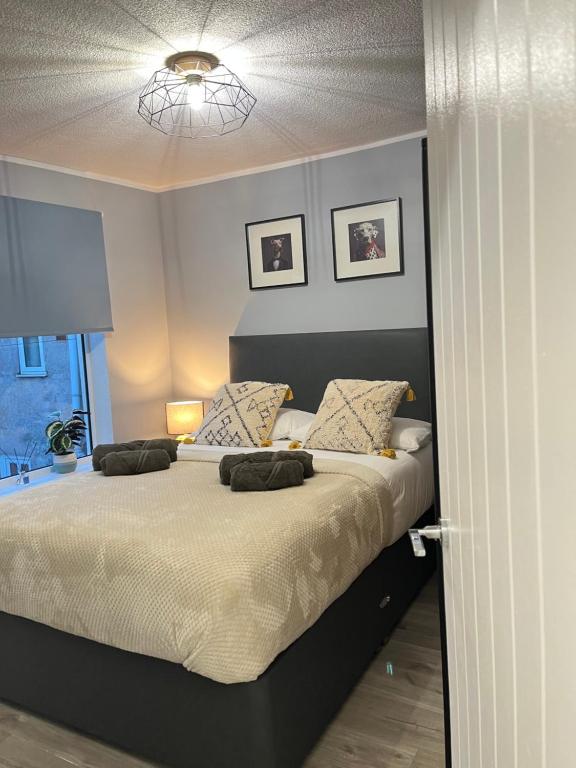 a bedroom with a large bed with two pillows at Urban Delight Escape in Great Yarmouth
