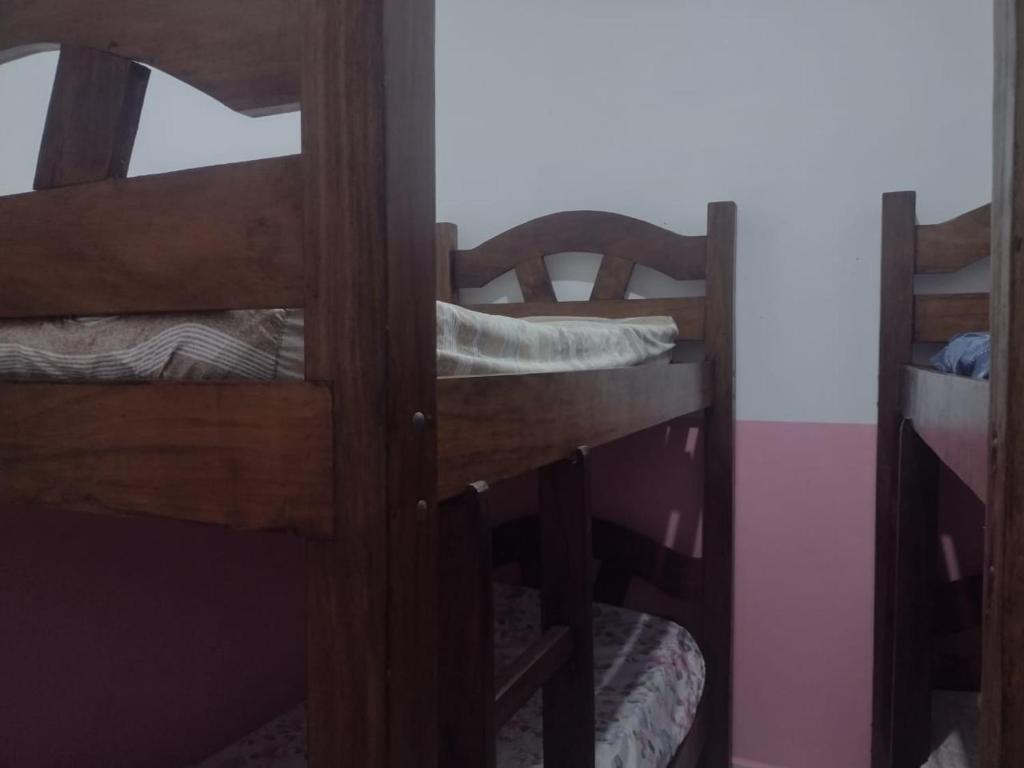 two bunk beds in a room with a mirror at Casa perto da praia mobiliada in Itanhaém