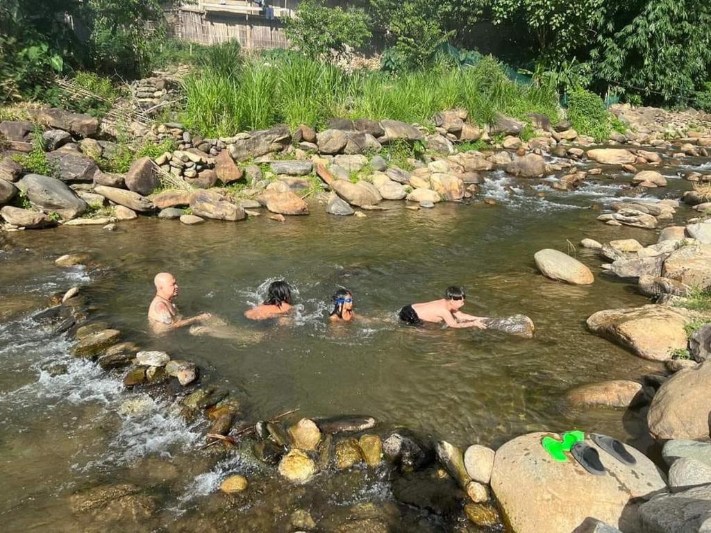 a group of people swimming in a river at Little House in KhauPha 