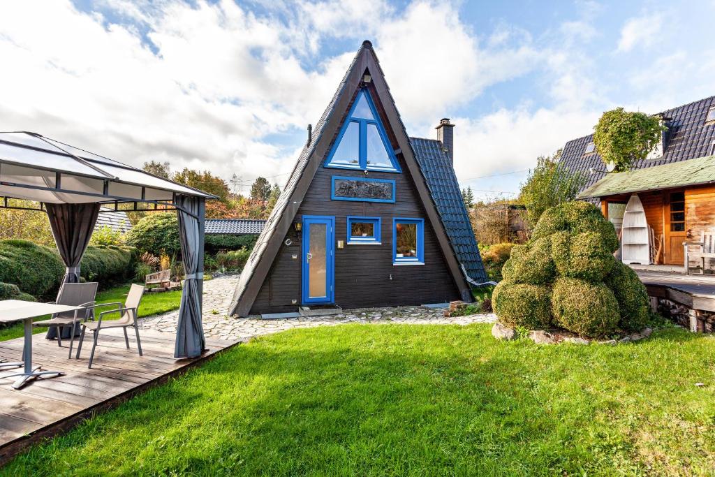 a tiny house with a gambrel roof at Villa Natura in Meschede