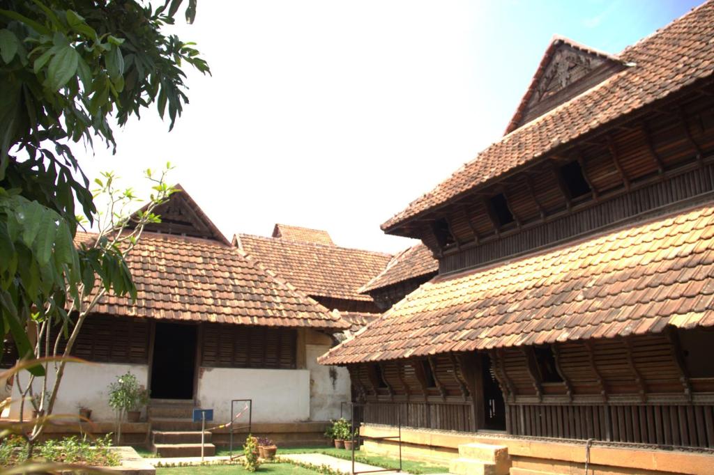 a group of buildings with tile roofs at Countryside inn in Tiruvankod