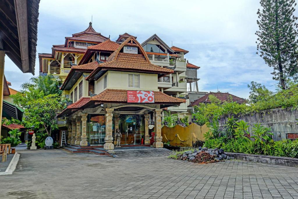 a large building with a store in front of it at Super OYO Collection O 91081 New Arena Hotel in Kuta