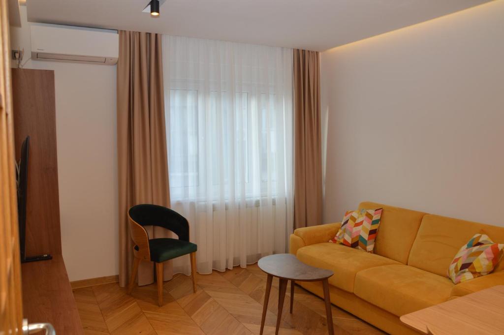 a living room with a couch and a chair at Unca in Belgrade
