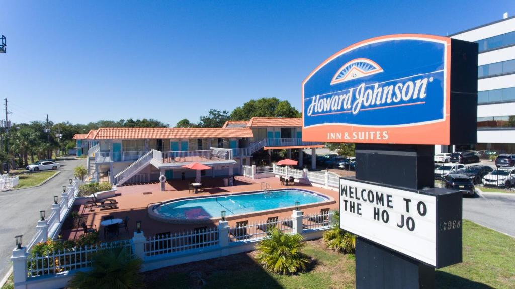 a sign for a hotel with a swimming pool at Howard Johnson by Wyndham Clearwater - Dunedin in Clearwater