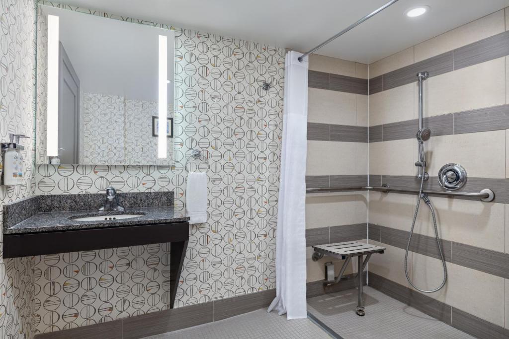 a bathroom with a sink and a shower at Holiday Inn Toronto Downtown Centre by IHG in Toronto