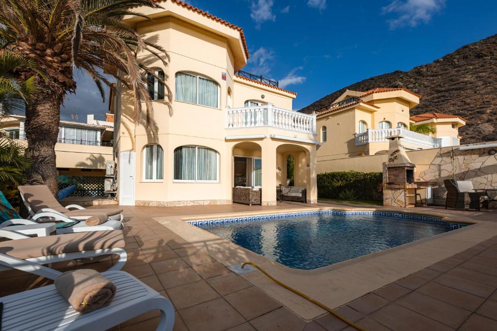 a villa with a swimming pool and a house at Villa Faya Ocean View With Private Pool in Los Cristianos