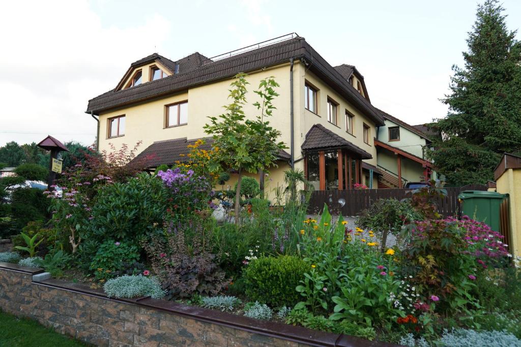 a house with a garden in front of it at Apartmany u Denyho in Zuberec