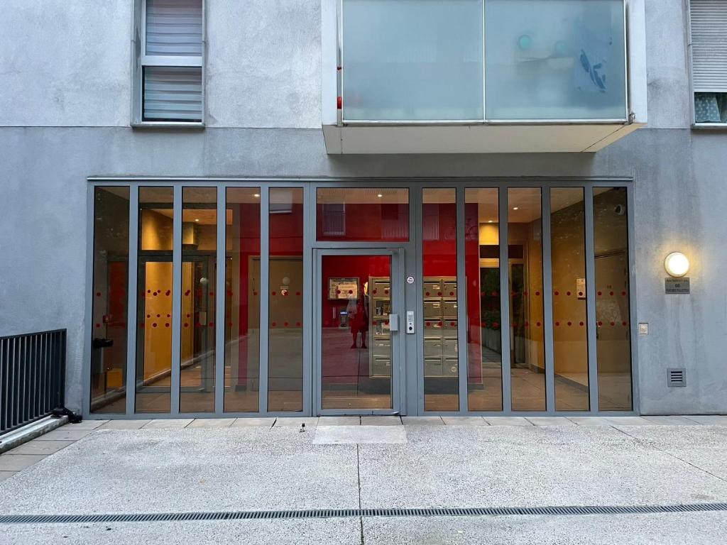 an entrance to a building with sliding glass doors at Nuit Étoilée in Aubervilliers
