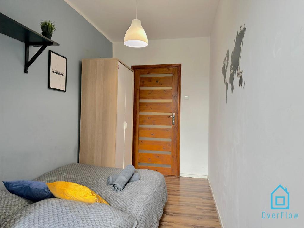a bedroom with a bed and a wooden door at World Room in Gdańsk