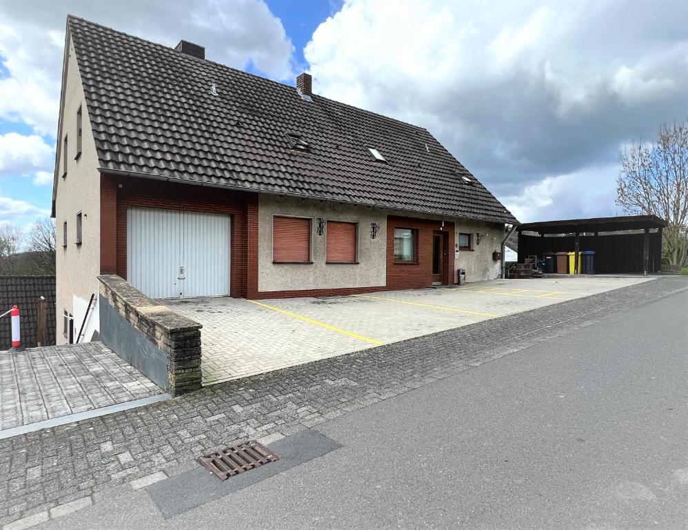 a house with a garage on the side of a street at GL-Oberkülheim in Bergisch Gladbach