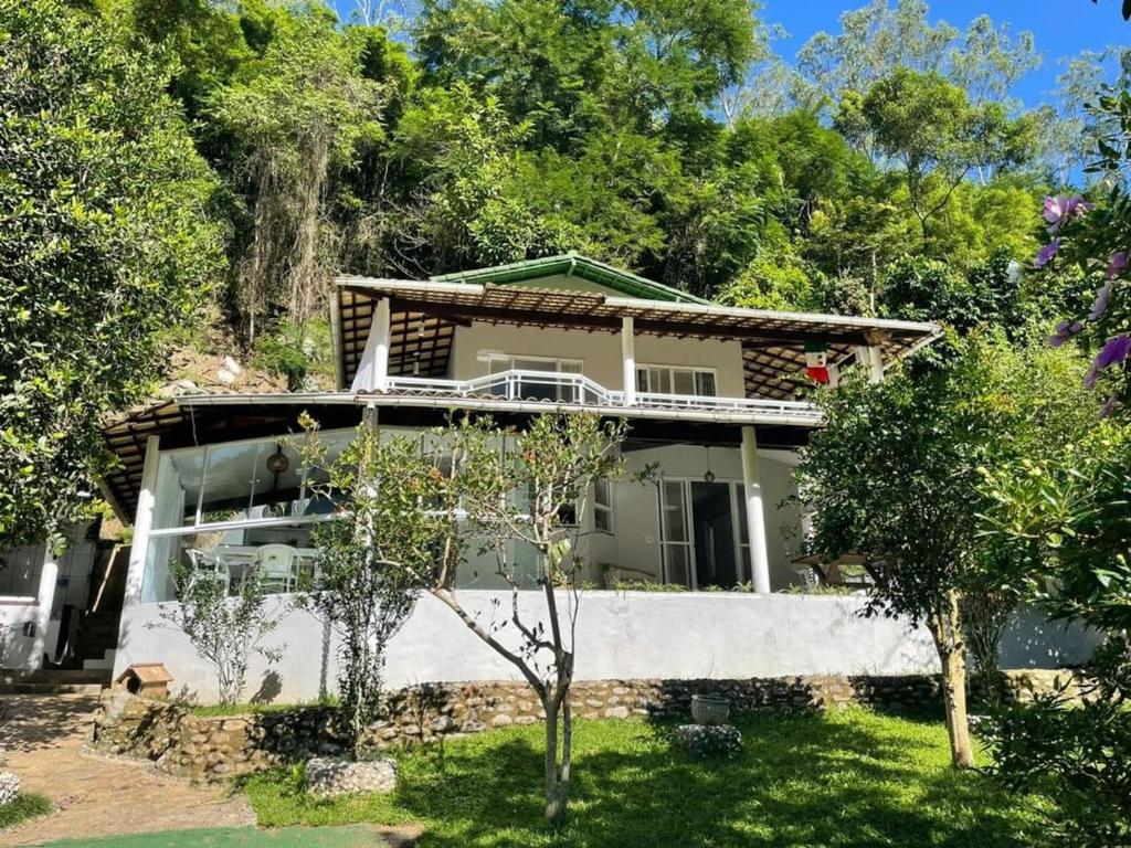 una casa con árboles delante en Casa beira Rio, en Sana