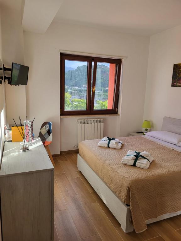 a bedroom with two beds and a window at Di Gioia Home B&B in Cosenza