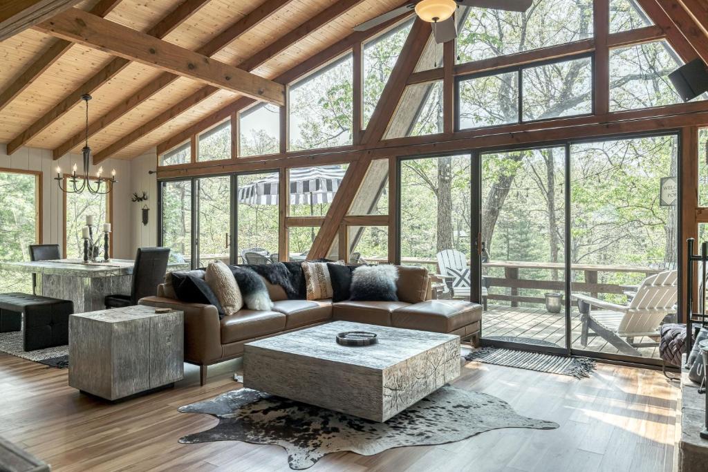 a living room with a couch and a table at 1236 Hideaway Lake Chalet by Sarah Bernard Chalets with Private Dock and Hot Tub in Innsbrook