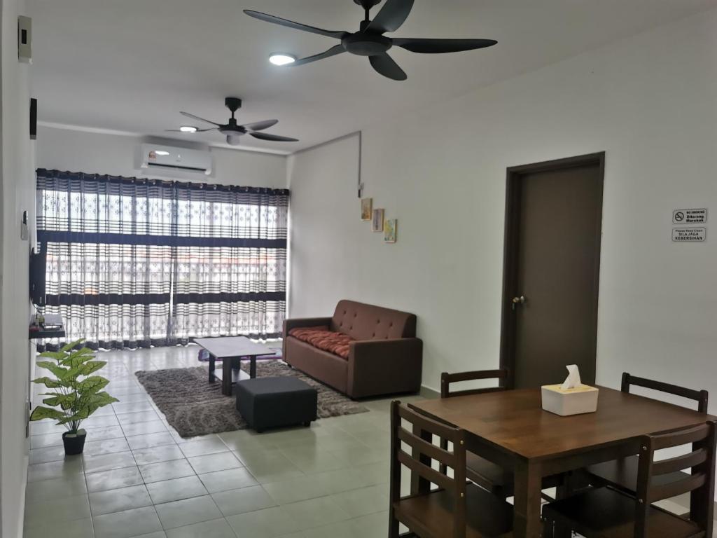 a living room with a couch and a table at Apartment Alor Gajah in Kampong Alor Gajah