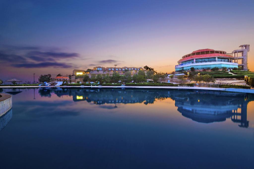 a large body of water with buildings in the background at Dreamworld Resort, Hotel & Golf Course in Karachi