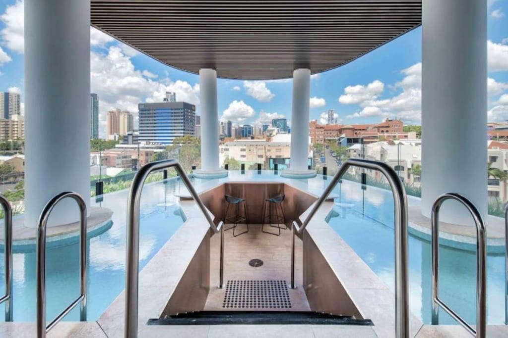 a swimming pool with a view of the city at Story Bridge and City View Skyhigh Luxe 2 bed Unit in Brisbane