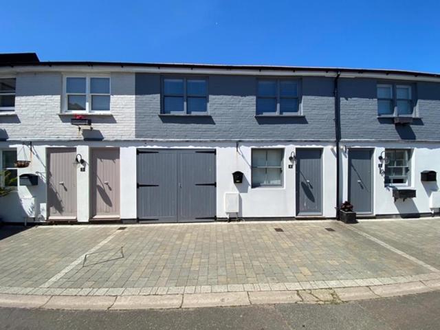 a building with four garage doors and a parking lot at 3 BEDROOMS WITH 2 PARKING SPACES in Brighton & Hove