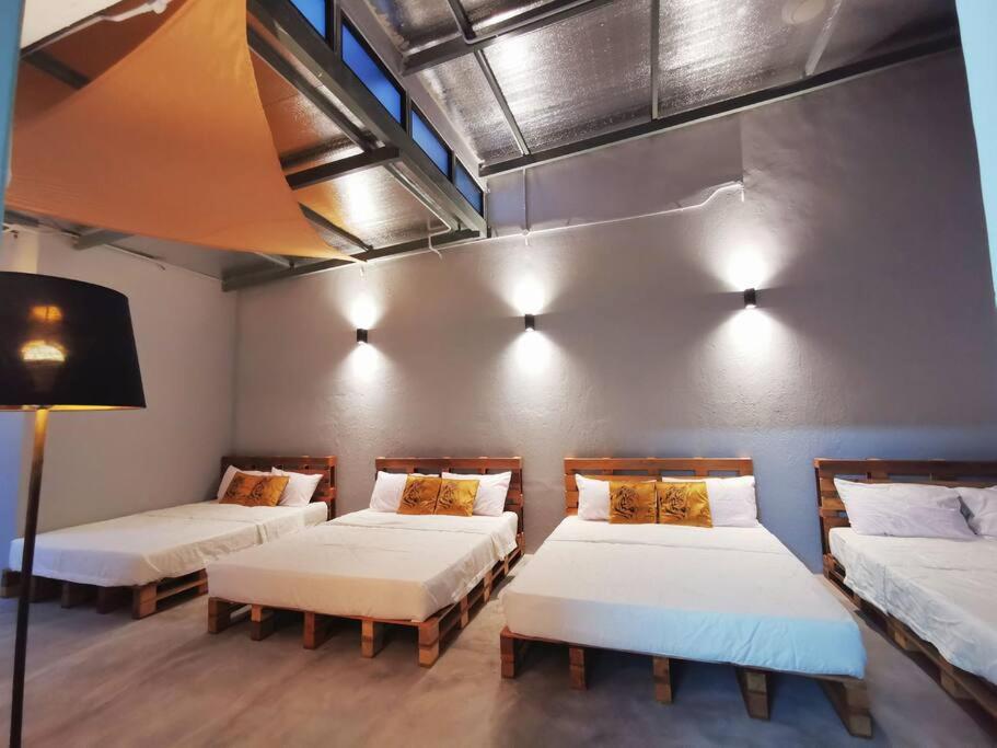 a room with two beds and a tv in it at Ipoh town centre glamping home 13pax in Ipoh