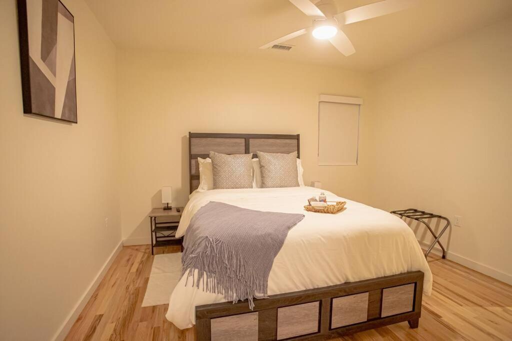 a bedroom with a large bed with a ceiling at Urban Oasis in Overton Square in Memphis