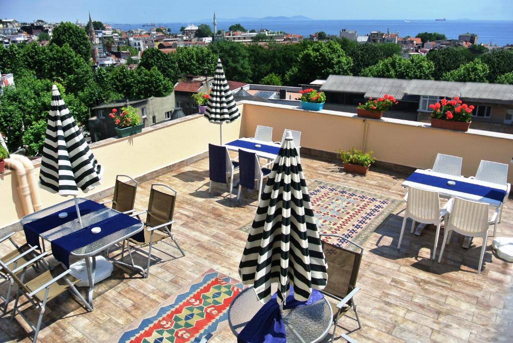a patio with tables and chairs on a roof at Fors Hotel in Istanbul