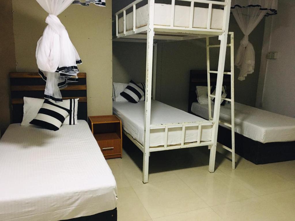 Postel nebo postele na pokoji v ubytování Aura City Hostel