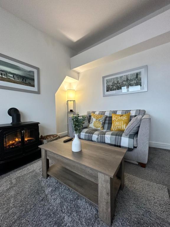 a living room with a couch and a fireplace at The Lookout, Bridlington in Bridlington