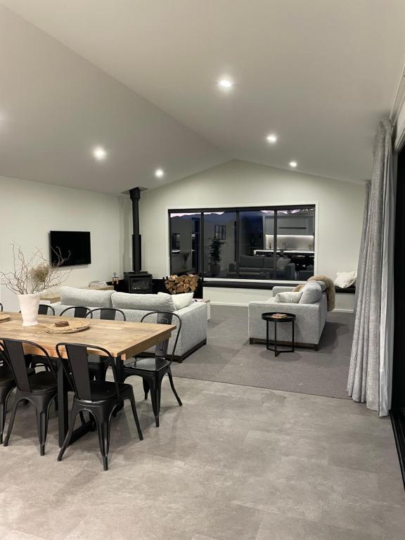 a living room with a table and a couch at Beckford House in Methven