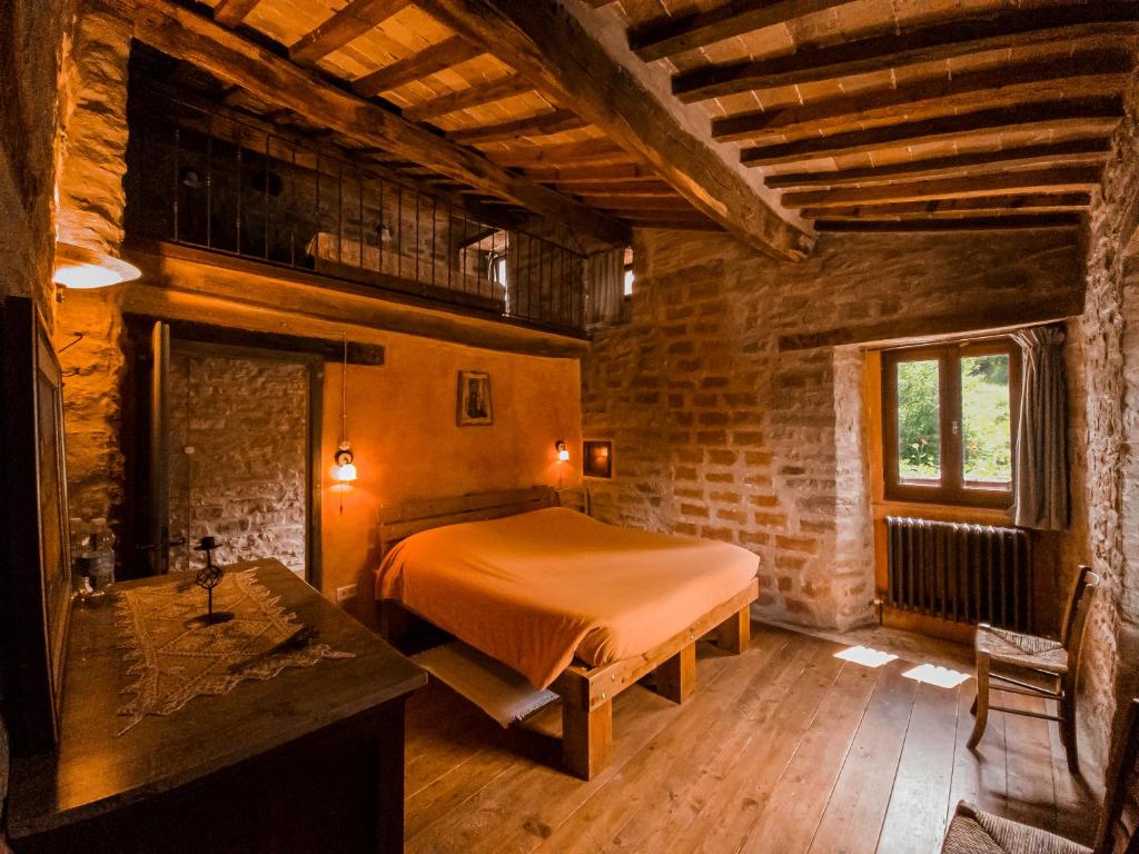 a bedroom with a bed in a brick room at Marzanella in Tredozio