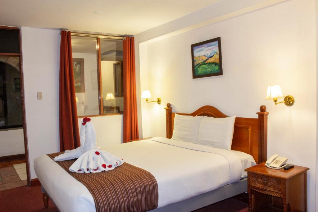 Postel nebo postele na pokoji v ubytování Hotel Amerinka