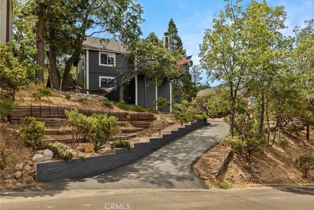 a house with a driveway in front of a house at Charming Getaway Cabin in Lake Arrowhead