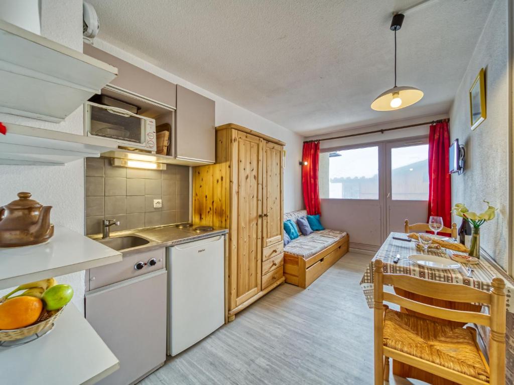 a kitchen and dining room with a table and chairs at Apartment Vanoise-12 by Interhome in Val Thorens