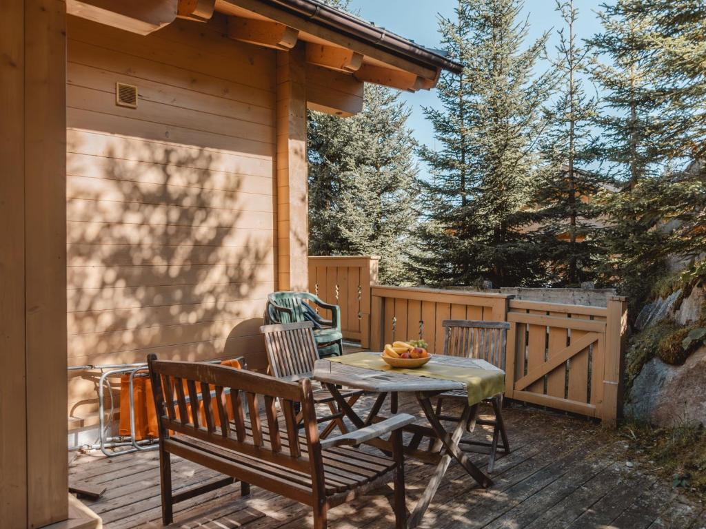 a patio with a table and chairs on a deck at Chalet Königsleiten 1 by Interhome in Königsleiten