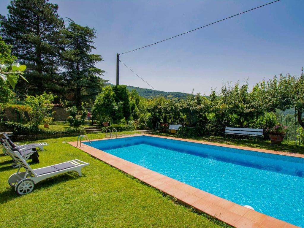 a swimming pool in the yard of a house at Holiday Home Allodola by Interhome in Scopeti