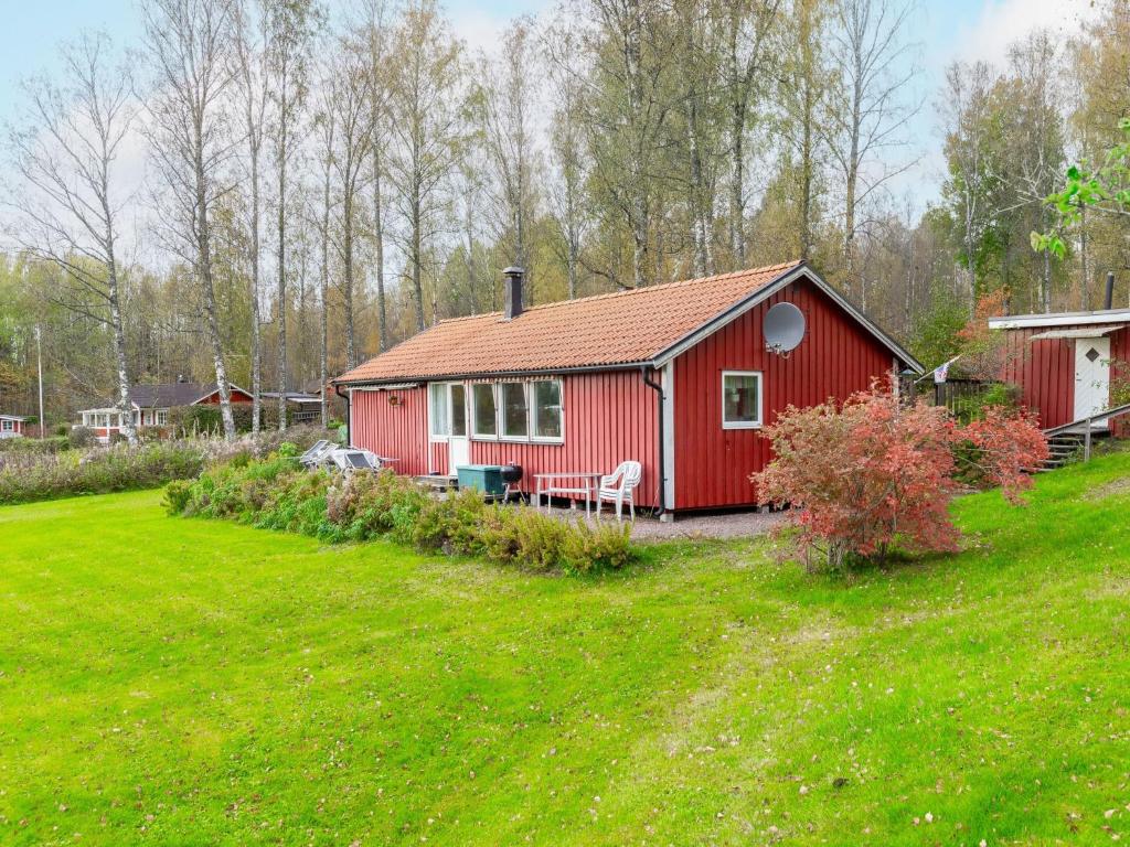 a red house in a field with a green yard at Holiday Home Gapern - VMD044 by Interhome in Killstad