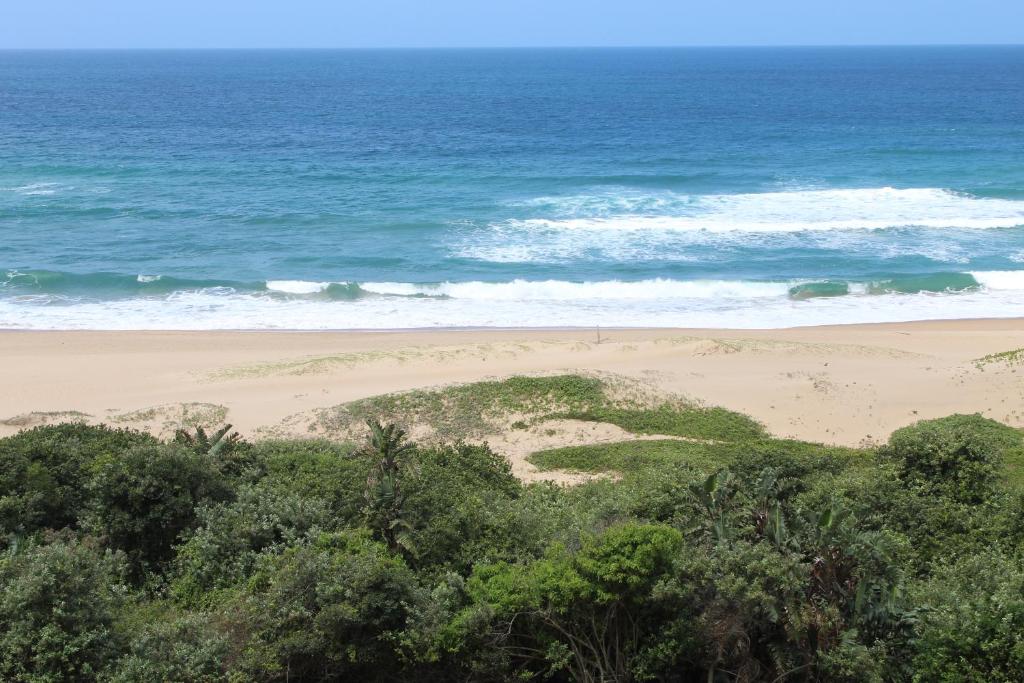 a view of a beach and the ocean at Afsaal Holiday Flats in Amanzimtoti